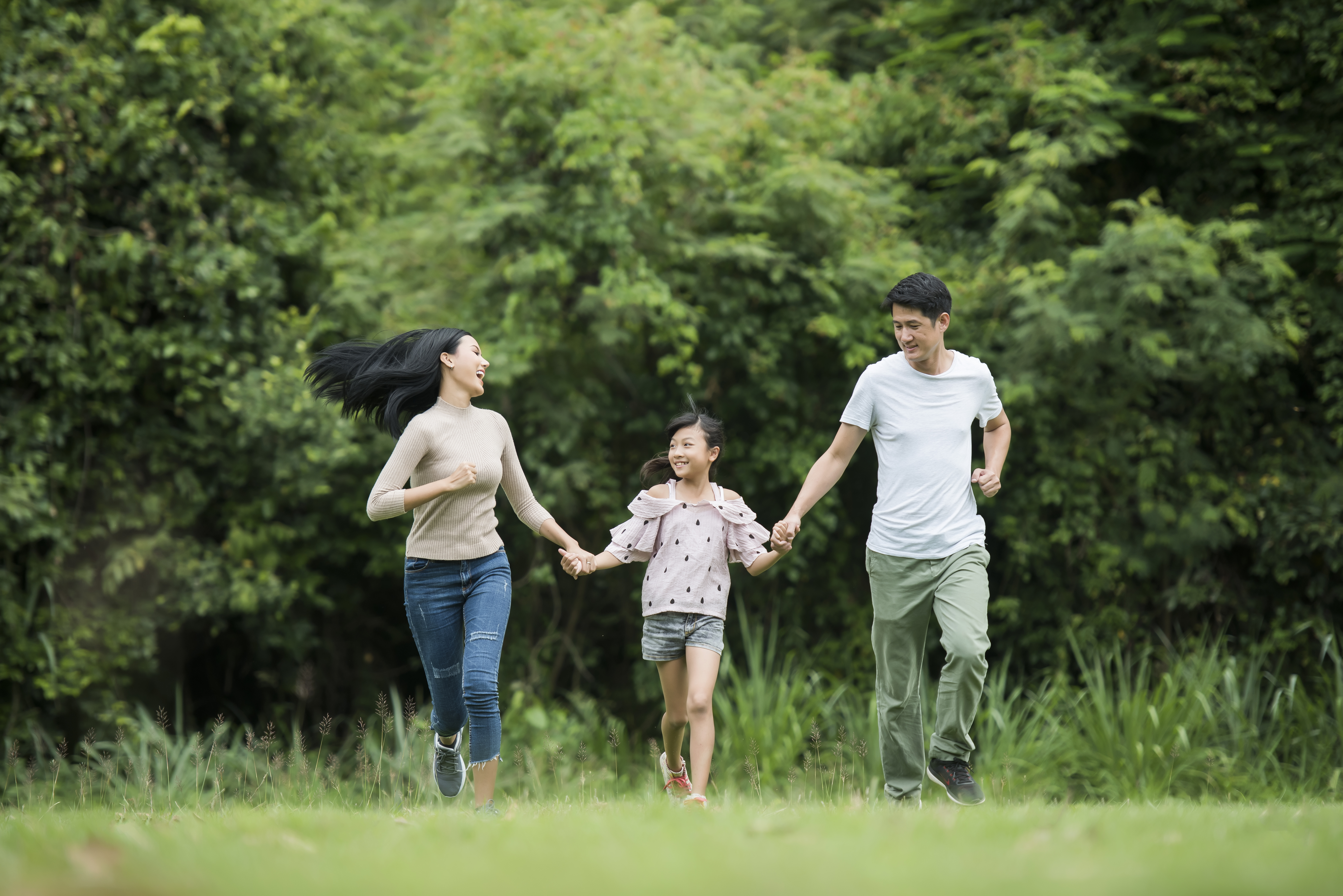 Happy family in the park — financial planning for Singapore families